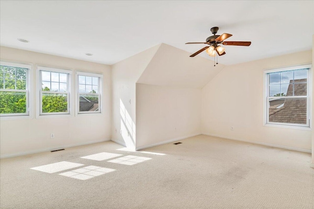 bonus room featuring light colored carpet, baseboards, a ceiling fan, and lofted ceiling