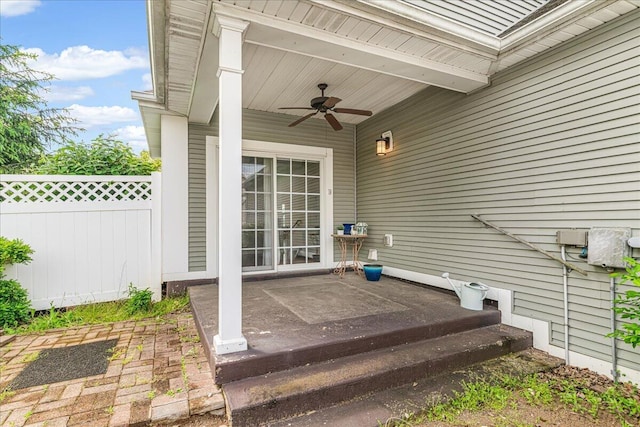 view of patio / terrace with ceiling fan and fence