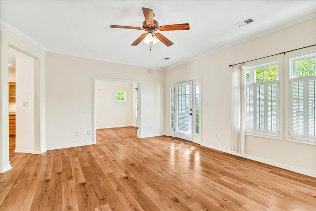 unfurnished room featuring light wood finished floors, plenty of natural light, a ceiling fan, and ornamental molding