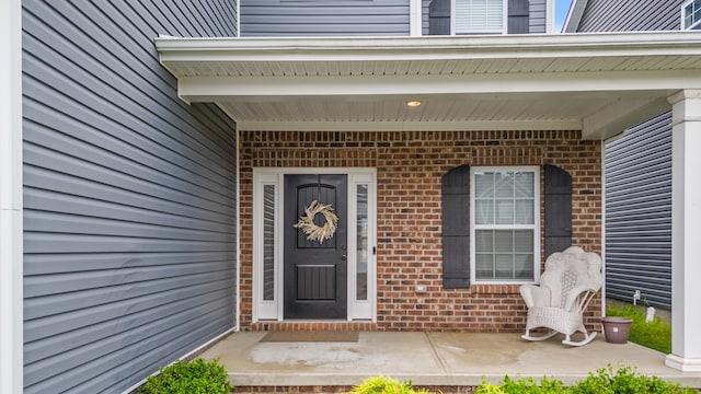 entrance to property with brick siding