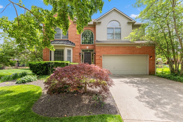 traditional home featuring a garage, brick siding, and concrete driveway