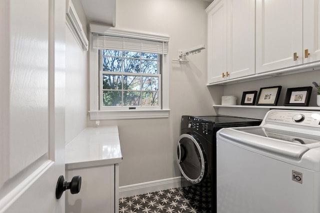 washroom with cabinet space, washing machine and dryer, baseboards, and tile patterned floors