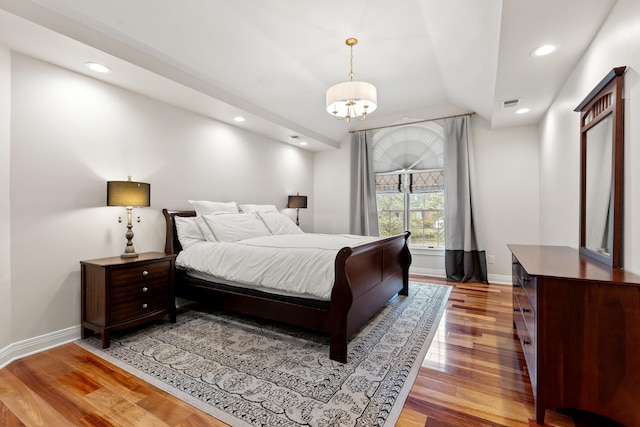 bedroom featuring light wood-type flooring, baseboards, recessed lighting, a chandelier, and lofted ceiling
