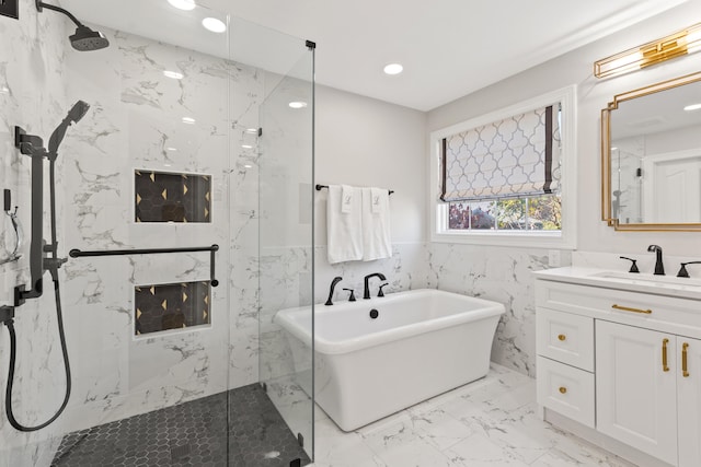 full bath with a marble finish shower, marble finish floors, a freestanding bath, recessed lighting, and vanity