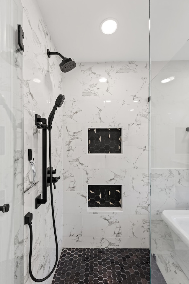 bathroom with a marble finish shower