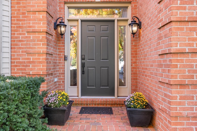 doorway to property with brick siding