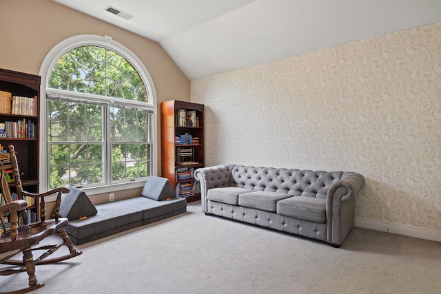 living room with carpet, healthy amount of natural light, wallpapered walls, lofted ceiling, and baseboards