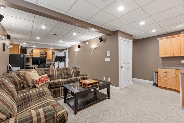 living area with an office area, light carpet, baseboards, recessed lighting, and a drop ceiling