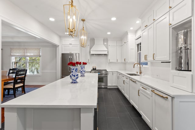 kitchen featuring custom range hood, high end appliances, a sink, a kitchen island, and recessed lighting