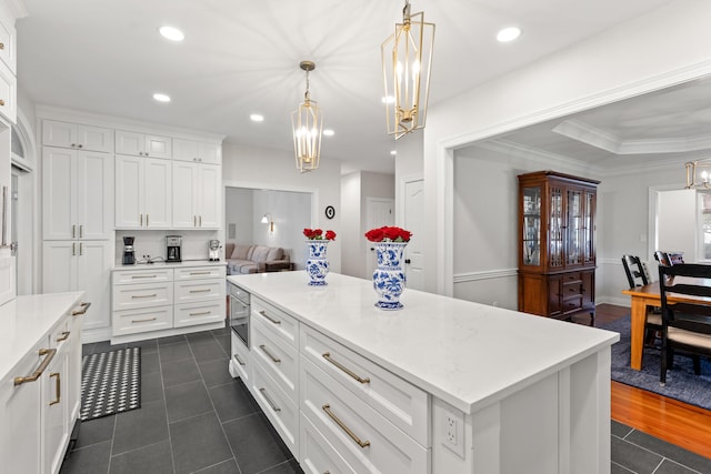 kitchen with a chandelier, white cabinetry, dark tile patterned flooring, hanging light fixtures, and recessed lighting
