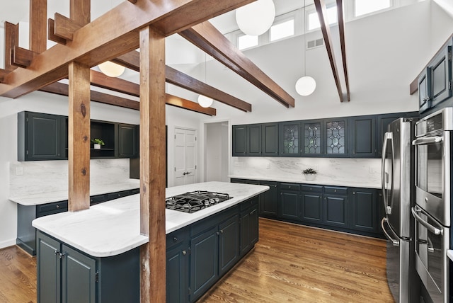 701 Old Dobbin Rd, Lexington, KY 40502 - kitchen featuring appliances with stainless steel finishes, backsplash, light countertops, a center island, and wood finished floors