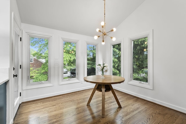 701 Old Dobbin Rd, Lexington, KY 40502 - dining space with baseboards, healthy amount of natural light, wood finished floors, and vaulted ceiling