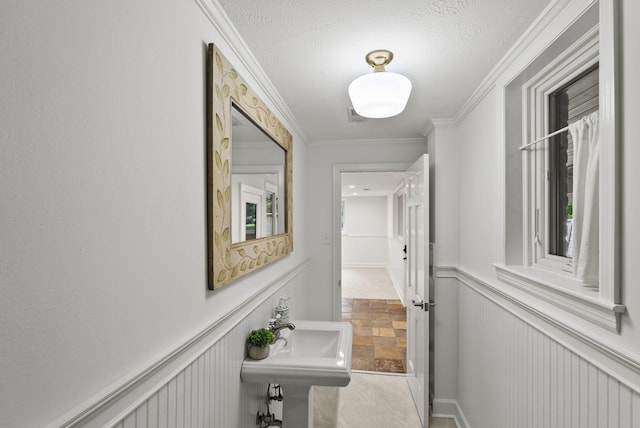 701 Old Dobbin Rd, Lexington, KY 40502 - corridor with a sink, stone finish flooring, a wainscoted wall, and ornamental molding