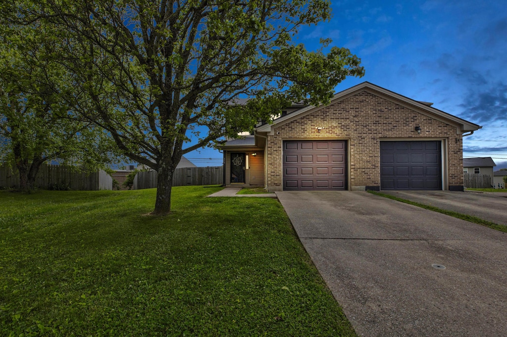 324 Essex Ct, Winchester, KY 40391 - view of front facade with driveway, brick siding, and an attached garage