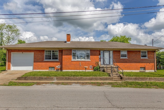view of front facade featuring a chimney, an attached garage, brick siding, concrete driveway, and roof with shingles