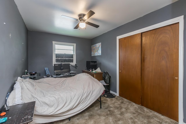bedroom with carpet, ceiling fan, a closet, and baseboards