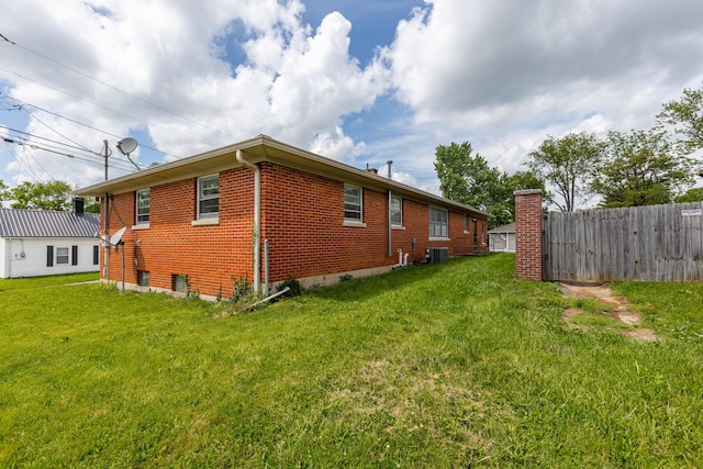 view of home's exterior with central AC unit and brick siding