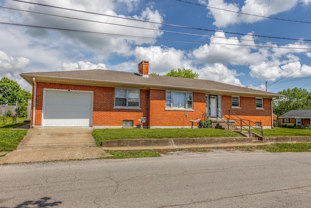 single story home featuring concrete driveway, a garage, brick siding, and a chimney