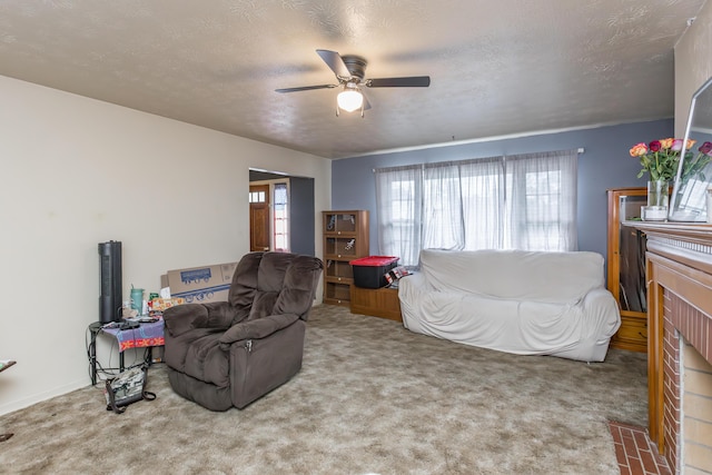 carpeted living area featuring plenty of natural light, a ceiling fan, a fireplace, and a textured ceiling