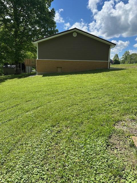 view of side of home with a lawn