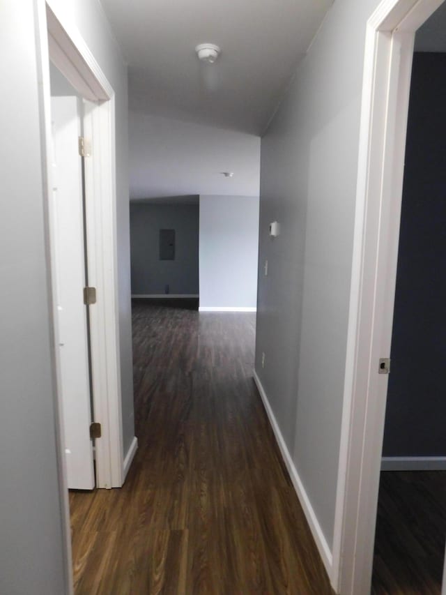 hallway with dark wood-style floors and baseboards