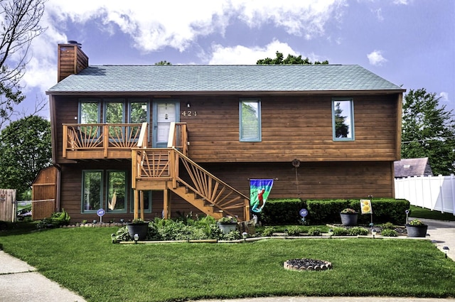 424 Woodcrest Pl, Lexington, KY 40517 - view of front facade featuring stairway, a chimney, a wooden deck, and a shingled roof