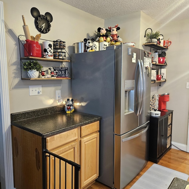 462 New Shiner Hill Rd, Williamsburg, KY 40769 - kitchen featuring stainless steel fridge, light wood-style floors, dark countertops, a textured ceiling, and open shelves