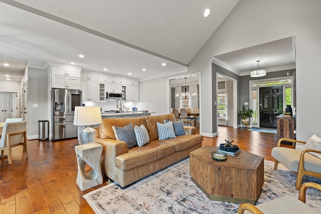 1342 Sugar Maple Ln, Lexington, KY 40511 - living room with crown molding, recessed lighting, dark wood-style floors, a chandelier, and vaulted ceiling