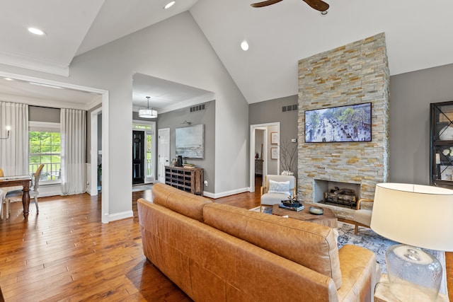 1342 Sugar Maple Ln, Lexington, KY 40511 - living room featuring hardwood / wood-style flooring, a stone fireplace, a ceiling fan, baseboards, and high vaulted ceiling