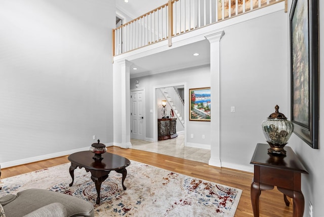 2221 Broadhead Pl, Lexington, KY 40515 - living room featuring ornate columns, a high ceiling, wood finished floors, baseboards, and stairway