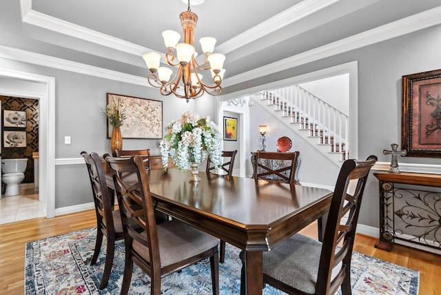 2221 Broadhead Pl, Lexington, KY 40515 - dining room with a chandelier, light wood-style flooring, stairs, baseboards, and ornamental molding