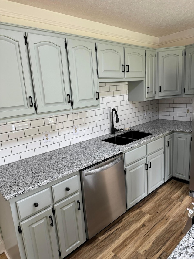 101 Megan Ct, Somerset, KY 42503 - kitchen with dishwasher, a sink, wood finished floors, backsplash, and light stone counters