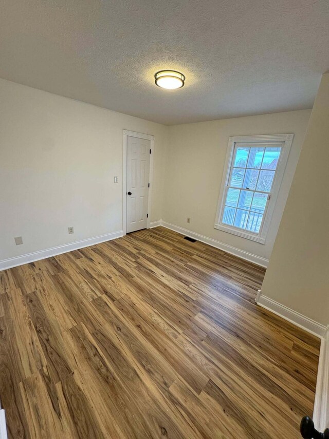 101 Megan Ct, Somerset, KY 42503 - unfurnished room featuring wood finished floors, a textured ceiling, and baseboards