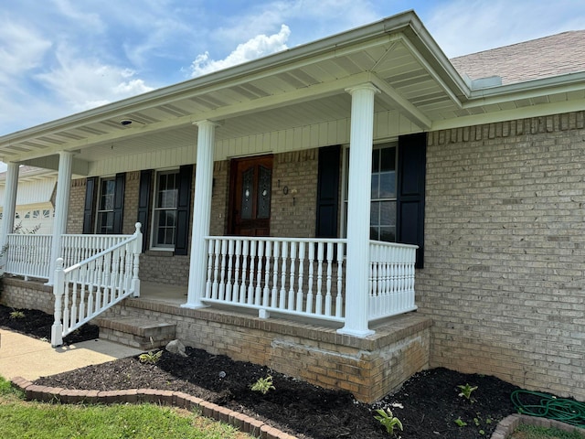 101 Megan Ct, Somerset, KY 42503 - property entrance featuring a porch, brick siding, and roof with shingles