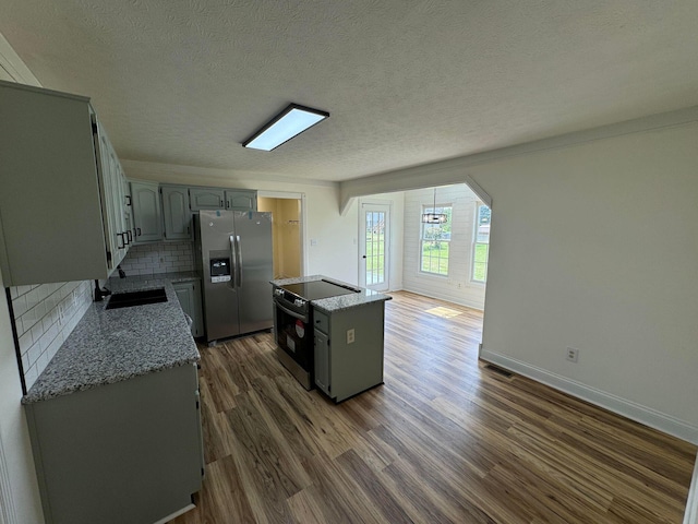 101 Megan Ct, Somerset, KY 42503 - kitchen featuring stainless steel appliances, backsplash, dark wood finished floors, a center island, and a textured ceiling