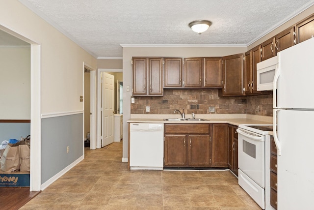 kitchen with white appliances, a sink, light countertops, tasteful backsplash, and a textured ceiling