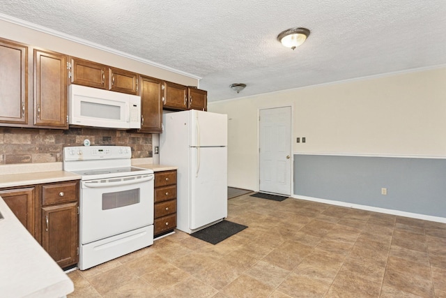 kitchen featuring white appliances, tasteful backsplash, light countertops, ornamental molding, and a textured ceiling