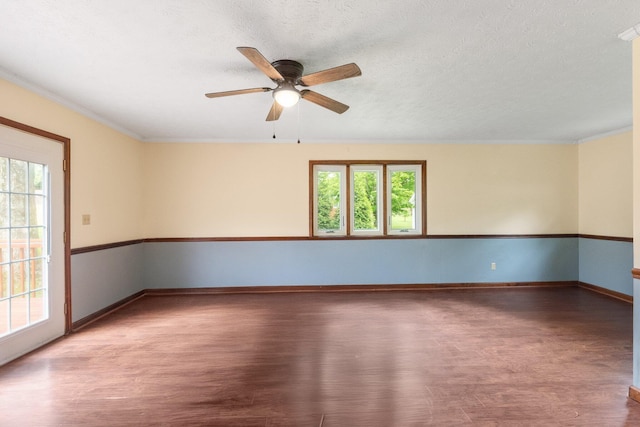unfurnished room featuring wood finished floors, ceiling fan, ornamental molding, baseboards, and a textured ceiling
