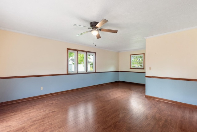 spare room with healthy amount of natural light, a ceiling fan, wood finished floors, and crown molding