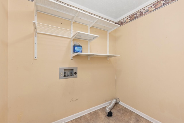 laundry room with washer hookup, baseboards, and tile patterned floors