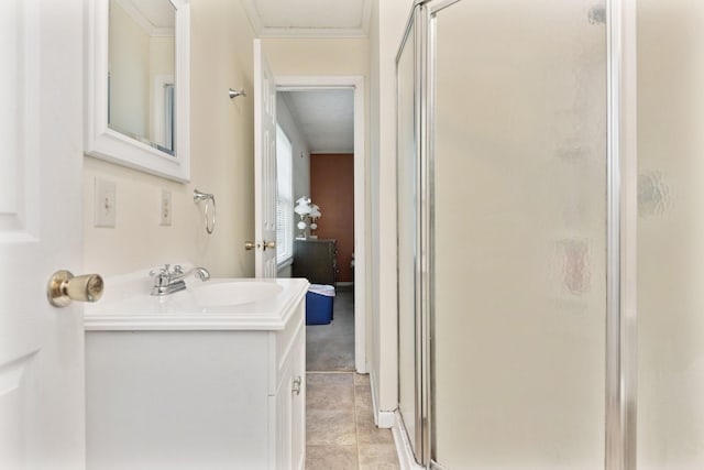 bathroom featuring a stall shower, vanity, tile patterned floors, and crown molding