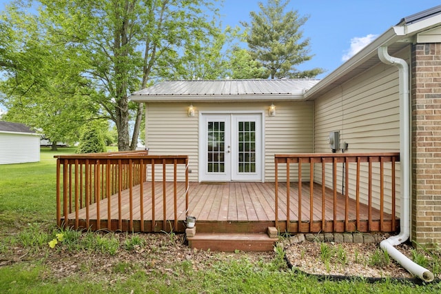 deck featuring french doors and a lawn