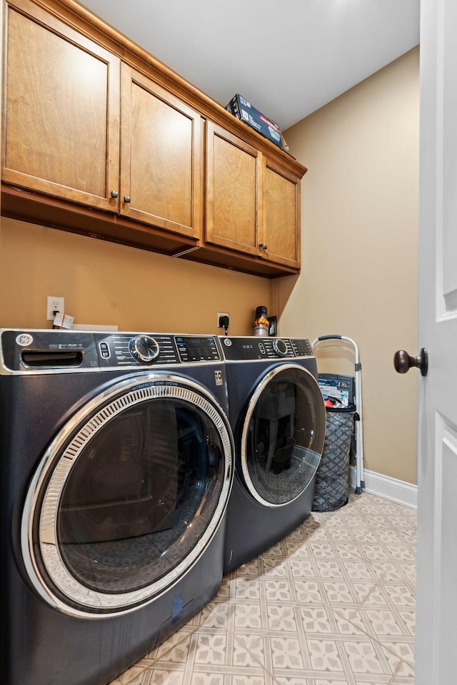 6031 Old S Dr, Richmond, KY 40475 - laundry area featuring cabinet space, washing machine and dryer, light flooring, and baseboards