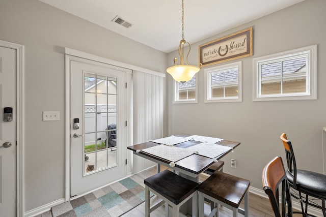 dining area featuring plenty of natural light, baseboards, and wood finished floors