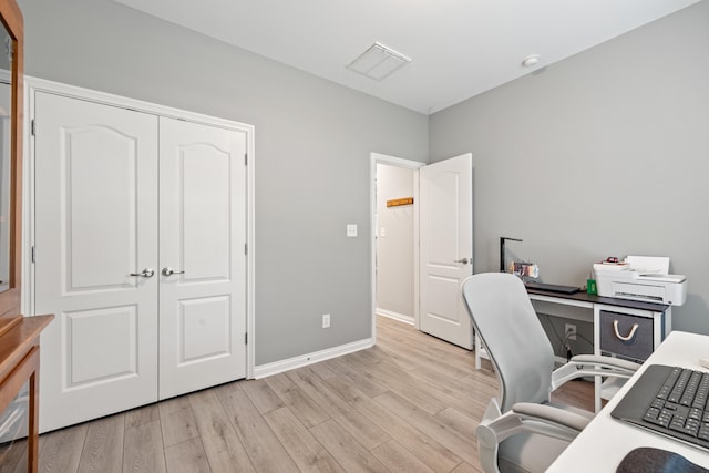 office featuring light wood-type flooring and baseboards