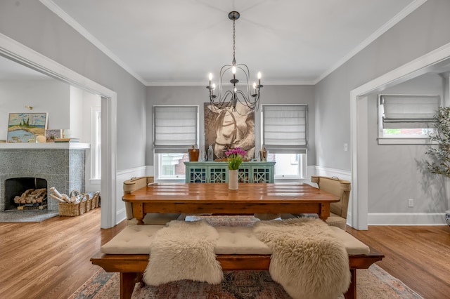 269 S Hanover Ave, Lexington, KY 40502 - dining area with wood finished floors, a chandelier, a fireplace, and crown molding