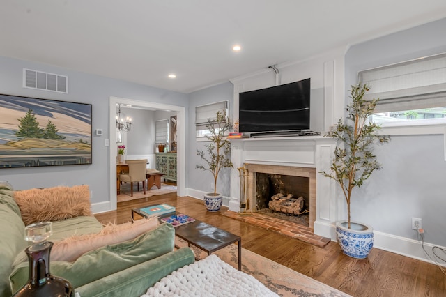 269 S Hanover Ave, Lexington, KY 40502 - living area with wood finished floors, baseboards, a fireplace with raised hearth, and recessed lighting