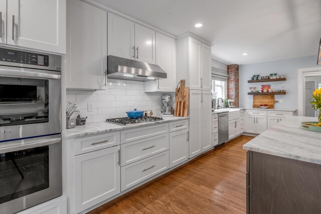 269 S Hanover Ave, Lexington, KY 40502 - kitchen featuring appliances with stainless steel finishes, under cabinet range hood, open shelves, white cabinetry, and light wood finished floors