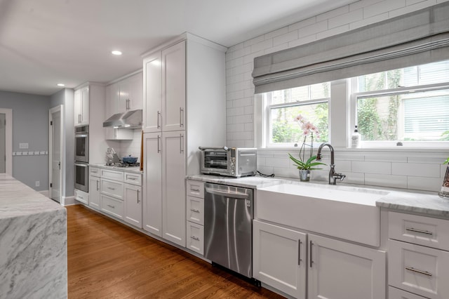 269 S Hanover Ave, Lexington, KY 40502 - kitchen with appliances with stainless steel finishes, a sink, under cabinet range hood, tasteful backsplash, and recessed lighting