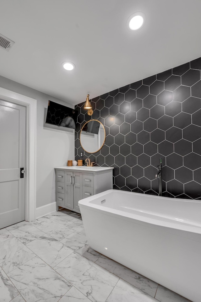 269 S Hanover Ave, Lexington, KY 40502 - full bathroom with marble finish flooring, recessed lighting, vanity, baseboards, and a freestanding tub